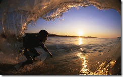 Male surfer riding ocean curl