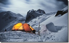 Illuminated tent of winter camp in the mountains