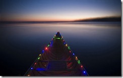Canoe decorated with Christmas lights on Lake Monona, Madison, Wisconsin, USA