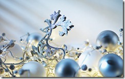 Silver and blue ornaments amongst fairy lights