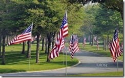Flags line the entrance of the Massachusetts National Cemetery in Bourne, Cape Cod, Massachusetts