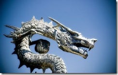 Chinese dragon statue against a blue sky, Spain